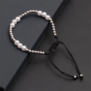 Detail of adjustable braided cord bracelet with white pearls and silver metal beads
