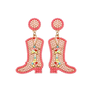 Macro shot of pink beaded cowboy boot earrings with gold trim and star patterns