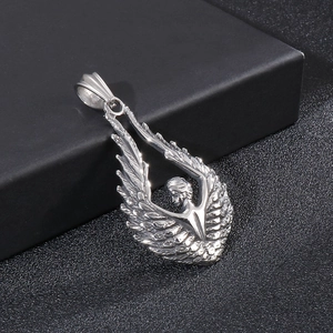 Detailed macro view of silver titanium steel angel wing pendant with figure carving