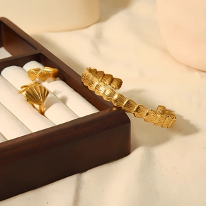 Golden starfish shell ring and open bracelet set in a wooden jewelry box display