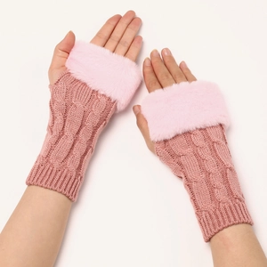 Detailed close-up of pink cable knit arm warmers with plush faux fur trim on wrists