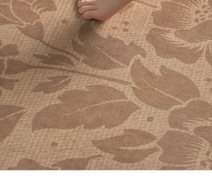 Close-up of floral pattern on waterproof woven rug showing soft texture with bare foot