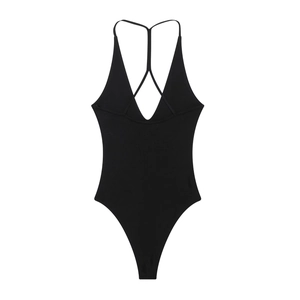 Detail of black ribbed knit bodysuit featuring thin dual straps and a deep V-neckline