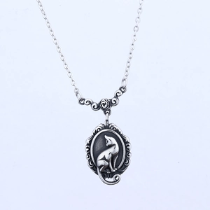 Vintage stainless steel oval cat wreath pendant on a delicate cross chain necklace