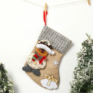Detailed jute Christmas stocking with snowman doll, snowflakes and wooden Merry Christmas sign