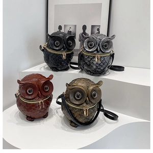 Detailed macro view of creative owl-shaped crossbody bags in four metallic colors