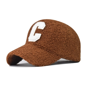 Close-up of the soft plush brown sherpa fabric and white letter C embroidery on the cap