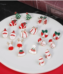 Detailed close-up of Christmas stud earrings collection with enamel holiday motifs