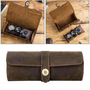 Detailed interior of vintage leather watch roll with velvet cushions for three watches