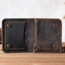 Detailed interior of vintage brown leather card holder with card slots and snap closure