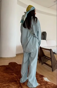 Back view of light blue loose linen-style shirt and wide-leg trousers set with a soft drape