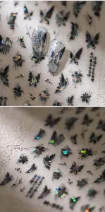 Macro detail of laser holographic butterfly nail stickers with Chinese ink art elements