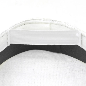 Detail showing elastic strap and sweatband inside white sequined military party hat