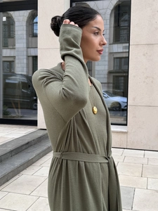 Detail of soft sage green knit cardigan and dress set featuring a tie waist belt