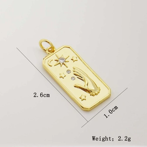 Detail view of a 2.6x1.0cm gold tarot pendant with sun and moon relief and zircon