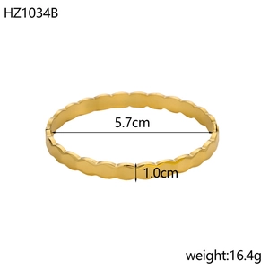 Macro shot of gold-plated wavy-edge bangle showing 5.7cm diameter and 1.0cm width measurements