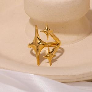 Minimalist gold stainless steel ring featuring three stars on a ceramic base