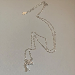 Macro detail of S925 sterling silver necklace featuring floral pendant and water drop gem