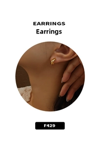 Close-up of elegant gold hoop earrings worn by a model in a minimalist style