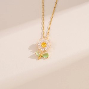 Elegant gold daisy pendant necklace with sparkling clear yellow and green zircons