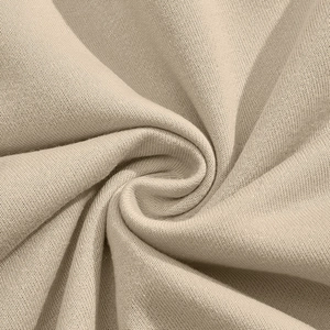 Detailed macro view of soft beige corduroy knit fabric texture with elegant folds