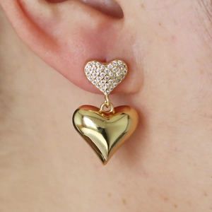 18K gold plated copper heart earrings with zircon stones on model's ear