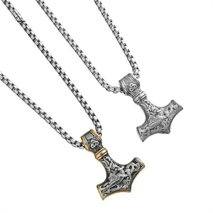 Detail view of Mjolnir hammer pendants in silver and gold finish with Viking runes