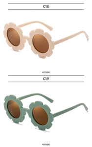 Detail view of flower-shaped kids sunglasses in beige and morandi green with matte finish