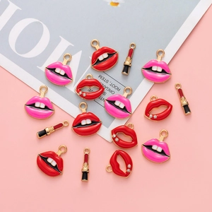 Detailed flat lay of red and pink enamel lipstick and lip charms for DIY jewelry making