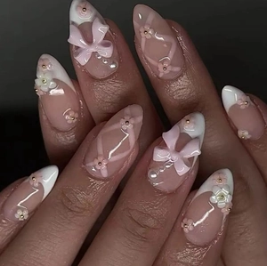 Nude pink almond press-on nails with white French tips, 3D flowers, and pink bows