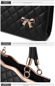 Détail du sac à main matelassé en cuir PU noir avec nœud doré et poignées renforcées