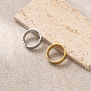 Minimalist adjustable titanium steel rings in gold and silver finish on stone base