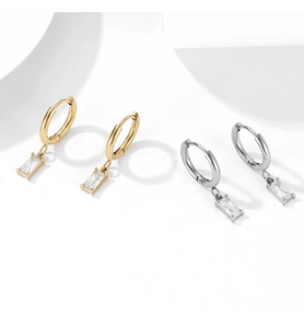 Close-up of vintage gold and silver stainless steel earrings with rectangle zircon pendants