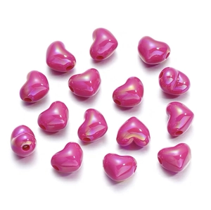 Detailed view of DIY magenta heart beads with iridescent finish for making jewelry