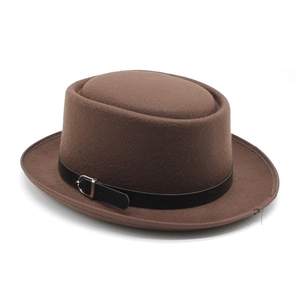 Detail of a brown felt pork pie hat featuring a black leather band and silver metal buckle