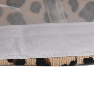 Detail of leopard print corduroy fabric with reinforced stitching on baseball cap