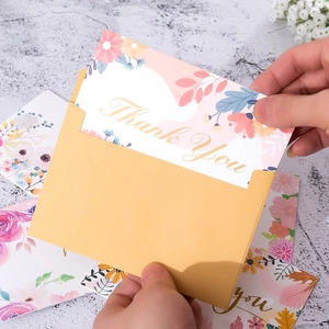 Floral Thank You cards with kraft envelopes on a grey marble table for holiday gifting