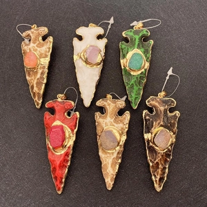 Arrowhead pendant charms in varied resin stone colors with gold plating and gem accents
