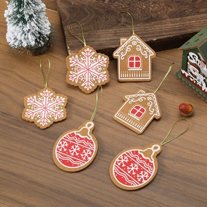 Set of 6 gingerbread themed felt Christmas tree ornaments on a warm wood background