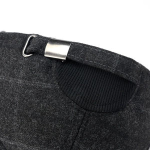 Detailed macro view of the dark grey wool cap featuring an adjustable silver metal buckle