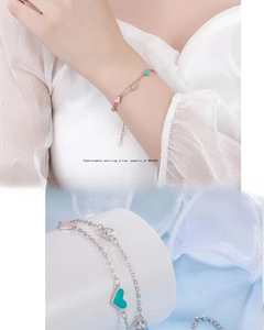 Detailed close-up of a double-layer S925 sterling silver heart bracelet with pink enamel