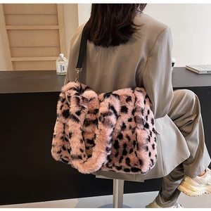 Pink leopard print plush tote bag with black strap and soft faux fur texture detail
