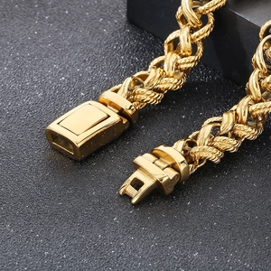 Macro view of golden heavy metal wheat weave chain with square mechanical buckle clasp