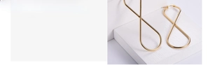 Detailed view of polished gold infinity-shaped titanium steel drop earrings for women