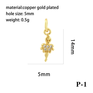Detailed view of gold plated ballerina pendant with size markings and clear gemstones