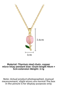 Detailed view of pink tulip pendant with dimensions of 2.6cm by 1cm on a gold steel chain
