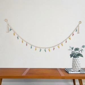 Handwoven cotton cord wall display with colorful metal clips and tassel accents