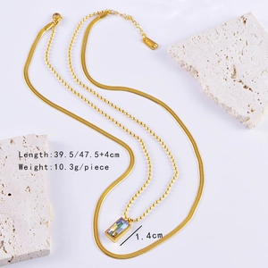 Close-up of double layer gold necklace with colorful rectangle gemstone and measurements