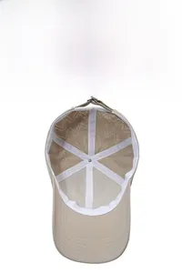 Detailed inner view of beige baseball cap with laser-cut ventilation holes and mesh lining