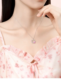 Detailed close-up of a S925 silver necklace with pink floral wreath pendant on neck